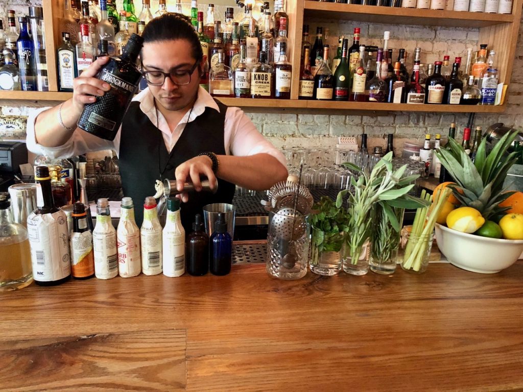 Salvador Rodriguez builds two Brockmans cocktails at The Warren in New York's Greenwich Village