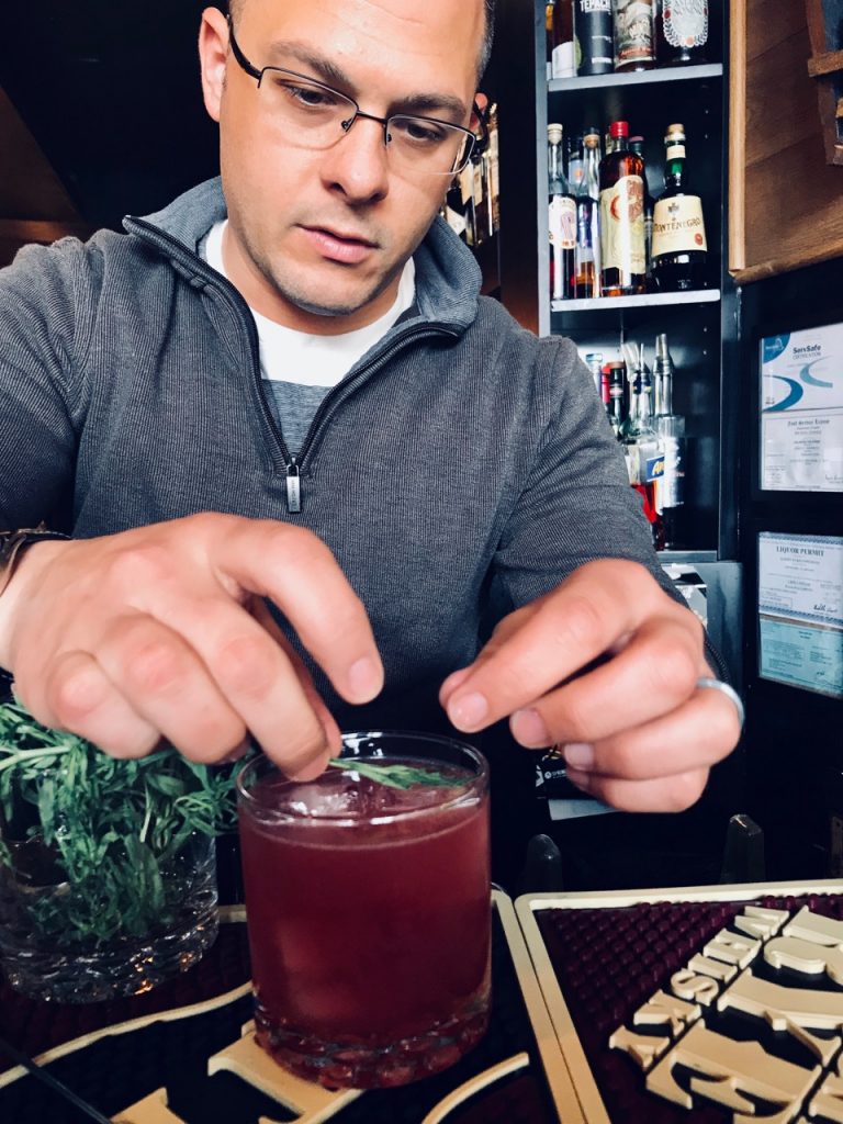 Albert Greenwood garnishes The Bramblin' Man at Oak Haven Table and Bar in New Haven, Connecticut